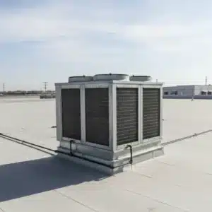 large industrial swamp cooler unit installed on a flat commercial rooftop